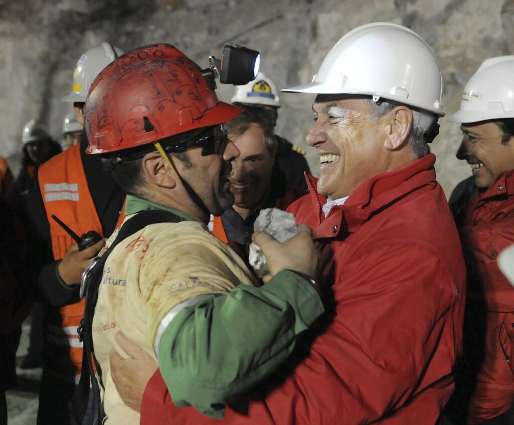 Chilean miner Mario Sepulveda embraces President Sebastian Pinera after he became the second miner to be rescued at the San Jose mine in Copiapo